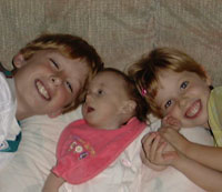 Claire with her big brother and big sister.